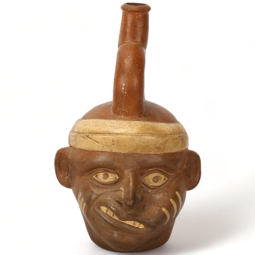 172 - A Pre-Columbian stirrup portrait vessel, museum/shop label to base dated 1935, height 23cm