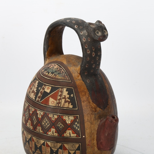 173 - A 16th century Peruvian terracotta ceremonial chicha pot, with puma handle and geometric painted pan... 