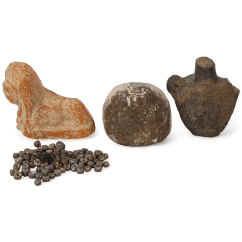 174 - Three Egyptian antiquities, including a terracotta sphinx and two stone carvings, together with anci... 