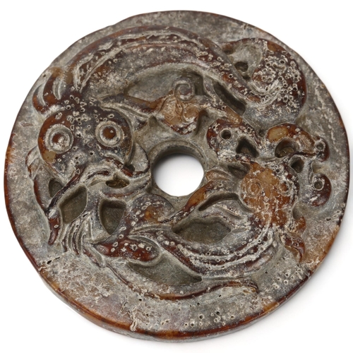 181 - A Chinese jade bi-disc with relief carved catfish design, diameter 5.5cm