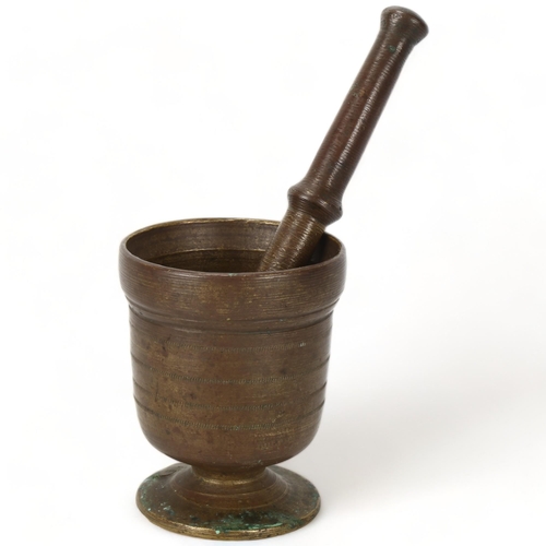 193 - A heavy bronze antique pestle and mortar, pestle length 23cm, mortar height 12cm