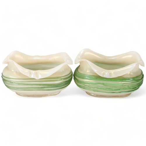 200 - A graduated pair of Loetz iridescent glass bowls, with trailed green glass decoration, largest lengt... 