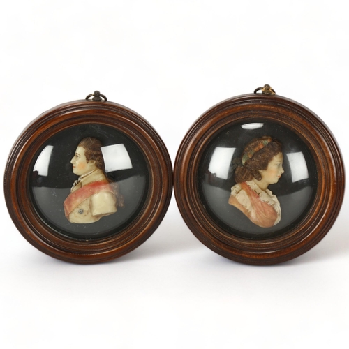 212 - A pair of coloured wax portraits of George III and Queen Charlotte, in mahogany frame with convex gl... 