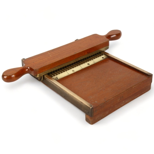 214 - A late 19th century mahogany and brass apothecary's pill making device, length 30cm