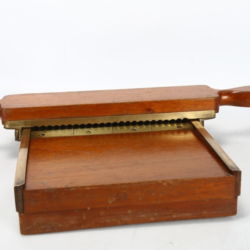 214 - A late 19th century mahogany and brass apothecary's pill making device, length 30cm