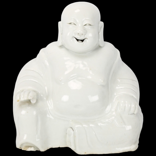 230 - A Chinese Blanc de Chine figure of a laughing Buddah, label under base 