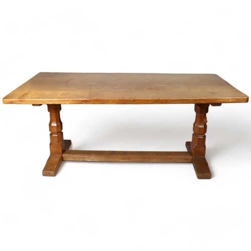 250 - Robert Mouseman Thompson, an oak refectory style dining table, with 4cm thick plank top, raised on o... 