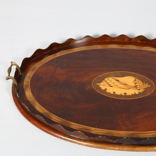 251 - A Georgian mahogany tray with inlay boxwood conch shell motif and brass handles, length 69cm