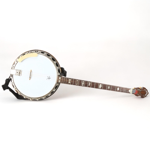 280 - **WITHDRAWN**A Clifford Essex & Son, Regal 401 four string banjo, with inlaid resonator, mother of p... 