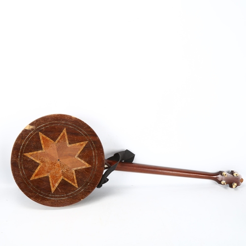 280 - **WITHDRAWN**A Clifford Essex & Son, Regal 401 four string banjo, with inlaid resonator, mother of p... 