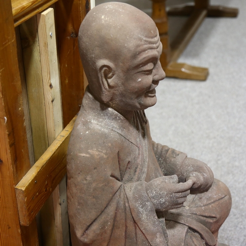 37 - A large and impressive Chinese seated figure carved from a single block of stone, the figure holding... 