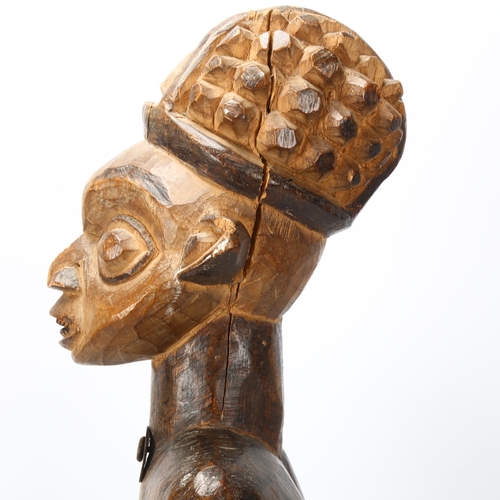 81 - An early/mid 20th century Cameroon carving, of a chief on a stool with a bats head mask, height 65cm