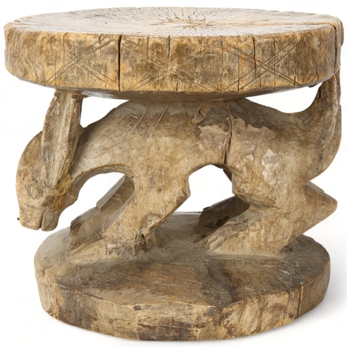 84 - An antique West African hardwood stool with carved Aardvark figure, height 24cm