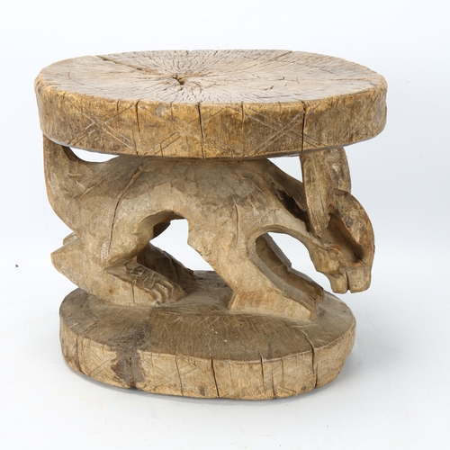 84 - An antique West African hardwood stool with carved Aardvark figure, height 24cm