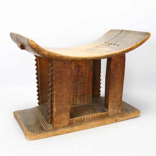 85 - An antique Ashanti stool, Ghana, with carved central column and supports, length 43cm, height 30cm