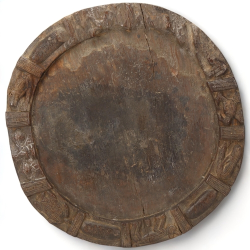 86 - A 19th century Yoruba, Nigeria, divination tray, with carved animal detail to edges, diameter 40cm