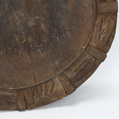 86 - A 19th century Yoruba, Nigeria, divination tray, with carved animal detail to edges, diameter 40cm