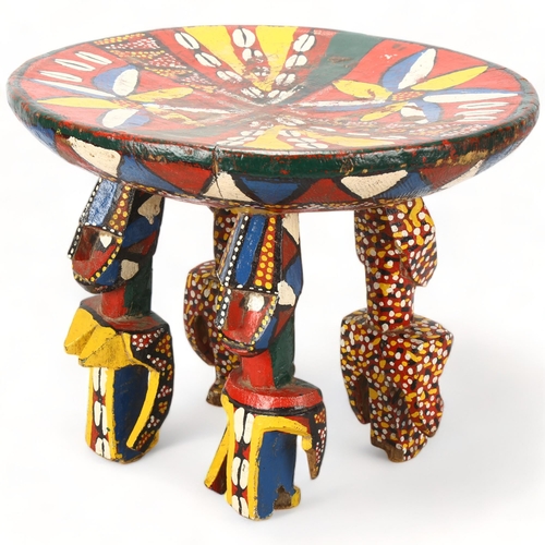 88 - A Bozo, Mali wood carved and painted stool, with male and female figure supports, height 30cm, diame... 