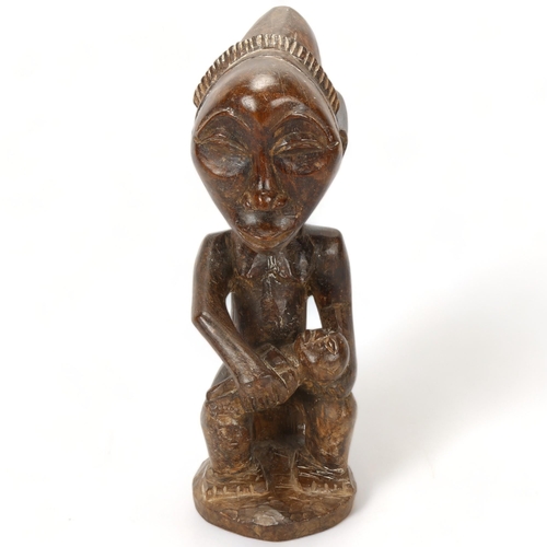 90 - A Luba, Congo, wood carved figure of mother and child in the style of the Buli Master, height 37cm