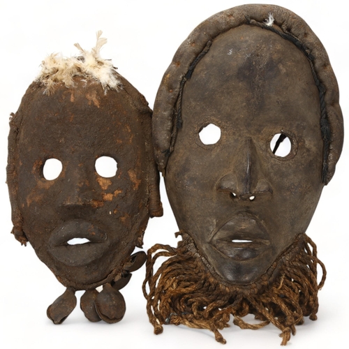 92 - Two African carved tribal masks, Dan, Ivory Coast, longest approx 34cm.