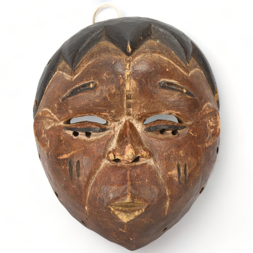 93 - A small Ibibio, Nigeria carved wood mask, height 17cm