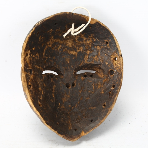 93 - A small Ibibio, Nigeria carved wood mask, height 17cm