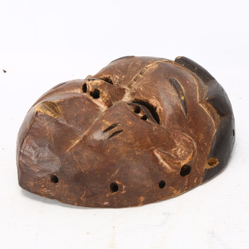 93 - A small Ibibio, Nigeria carved wood mask, height 17cm