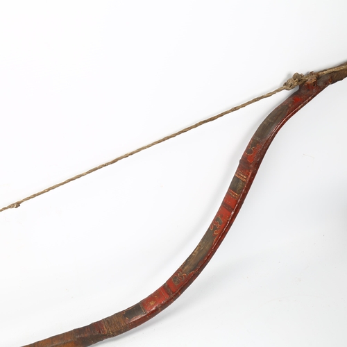 94 - A traditional Mongolian bow,  wood construction with painted chevron detail and leather strapping, l... 