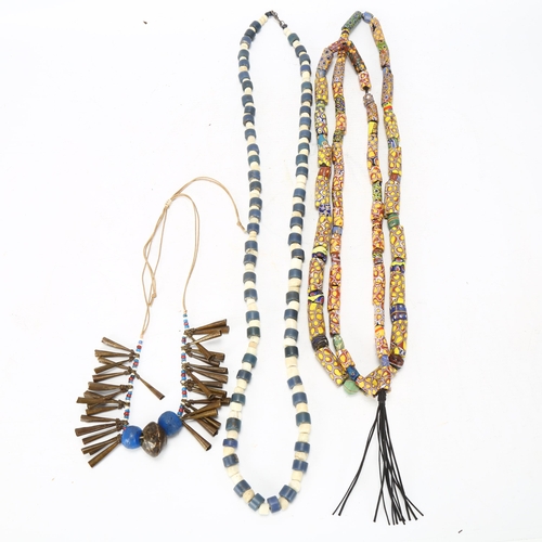 96 - Three strings of African tribal beads, glass millefiore, blue and white Ugandan beads and North Afri... 