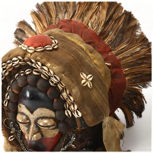 78E - A large Dan, Ivory Coast headdress, with feather and shell decoration, height approx 56cm