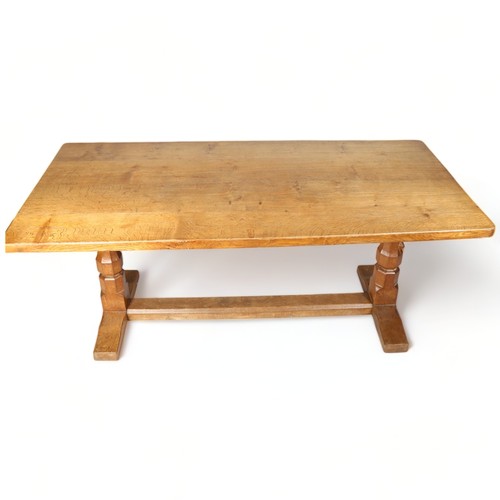 250 - Robert Mouseman Thompson, an oak refectory style dining table, with 4cm thick plank top, raised on o... 