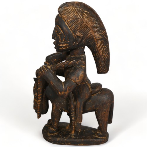 104A - A Yoruba, West African wood carved figure on horse, height 47cm