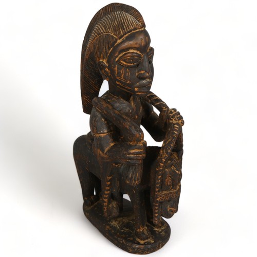 104A - A Yoruba, West African wood carved figure on horse, height 47cm