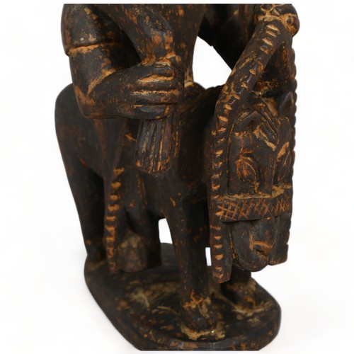 104A - A Yoruba, West African wood carved figure on horse, height 47cm