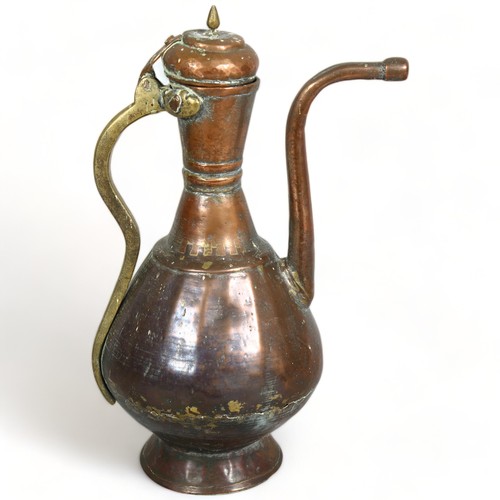 289 - An antique Middle Eastern teapot, hand wrought copper and brass, height 40cm