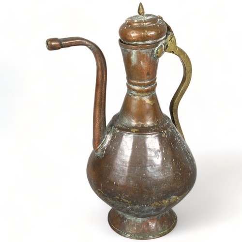 289 - An antique Middle Eastern teapot, hand wrought copper and brass, height 40cm