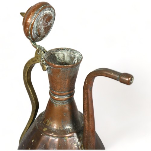 289 - An antique Middle Eastern teapot, hand wrought copper and brass, height 40cm