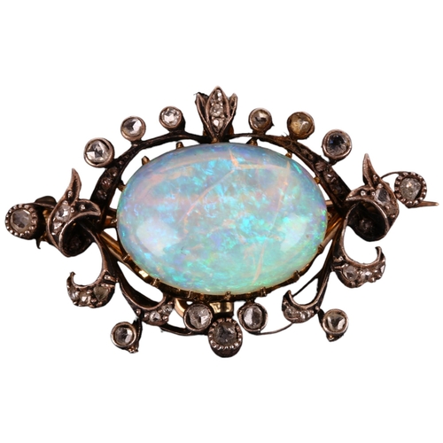 1106 - An Art Nouveau opal and diamond openwork pendant/brooch, circa 1905, centrally claw set with 4.25ct ... 