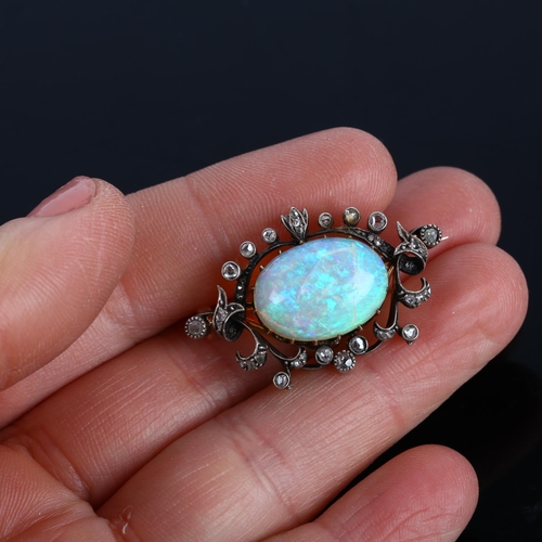 1106 - An Art Nouveau opal and diamond openwork pendant/brooch, circa 1905, centrally claw set with 4.25ct ... 