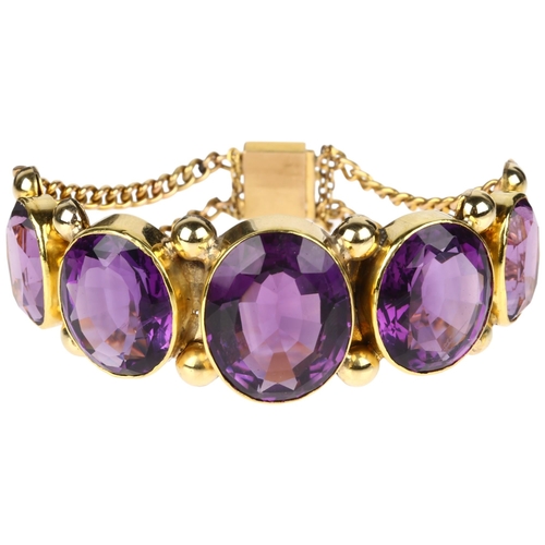 1109 - A large Victorian graduated five stone amethyst bracelet, circa 1860, rub-over set with oval mixed-c... 