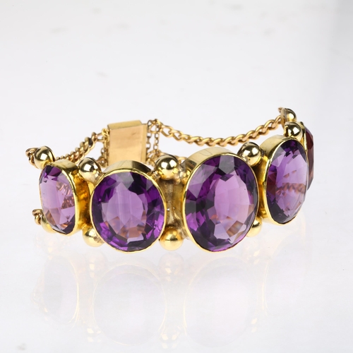 1109 - A large Victorian graduated five stone amethyst bracelet, circa 1860, rub-over set with oval mixed-c... 