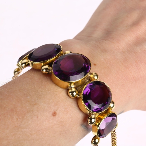 1109 - A large Victorian graduated five stone amethyst bracelet, circa 1860, rub-over set with oval mixed-c... 