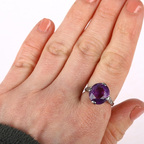 1111 - An Art Deco amethyst and diamond dress ring, claw set with oval mixed-cut amethyst and round-cut dia... 