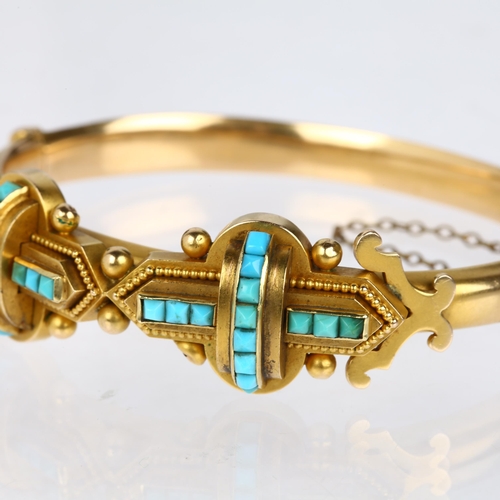 1116 - A Victorian 15ct gold Etruscan Revival turquoise hinged bangle, circa 1880, the central double cross... 