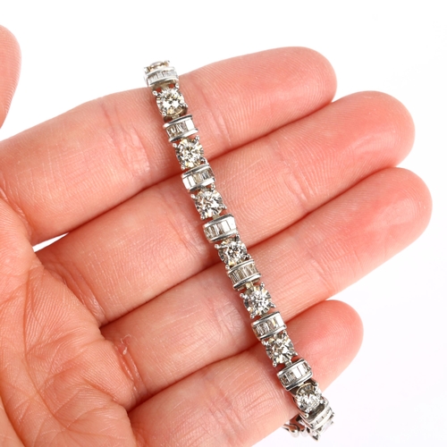 1126 - An American 10k white gold diamond tennis line bracelet, set with modern round brilliant and baguett... 