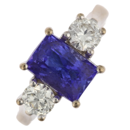 1128 - An 18ct white gold three stone tanzanite and diamond ring, maker AFJ, London 2016, centrally claw se... 