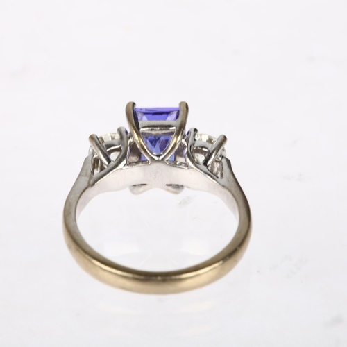 1128 - An 18ct white gold three stone tanzanite and diamond ring, maker AFJ, London 2016, centrally claw se... 