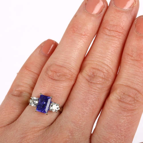 1128 - An 18ct white gold three stone tanzanite and diamond ring, maker AFJ, London 2016, centrally claw se... 