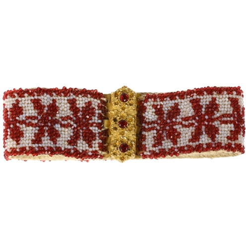 1134 - A Georgian garnet and glass beaded cuff bracelet, circa 1800, the gilt-metal floral clasp suspending... 