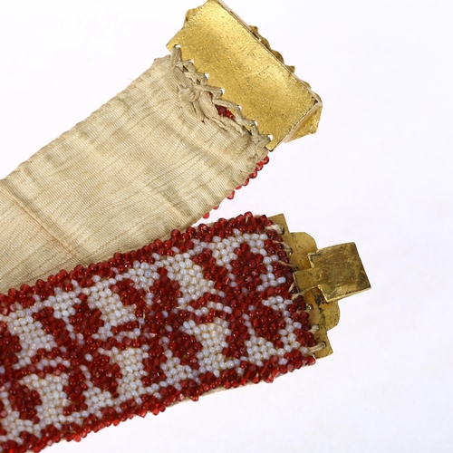 1134 - A Georgian garnet and glass beaded cuff bracelet, circa 1800, the gilt-metal floral clasp suspending... 